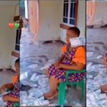 Mother acts unbothered as son sprays her loads of cash (Video)