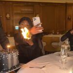 Moment lady's outfit catches fire while making video of birthday cake
