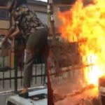 Woman sets fire on fence to repel 'landgrabbers' attempting to take over her family house in Lagos (Video)