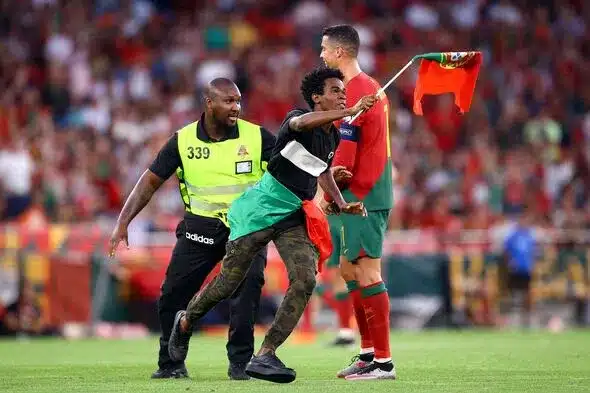 Ronaldo lifted up by pitch invader during Euro qualifiers match 