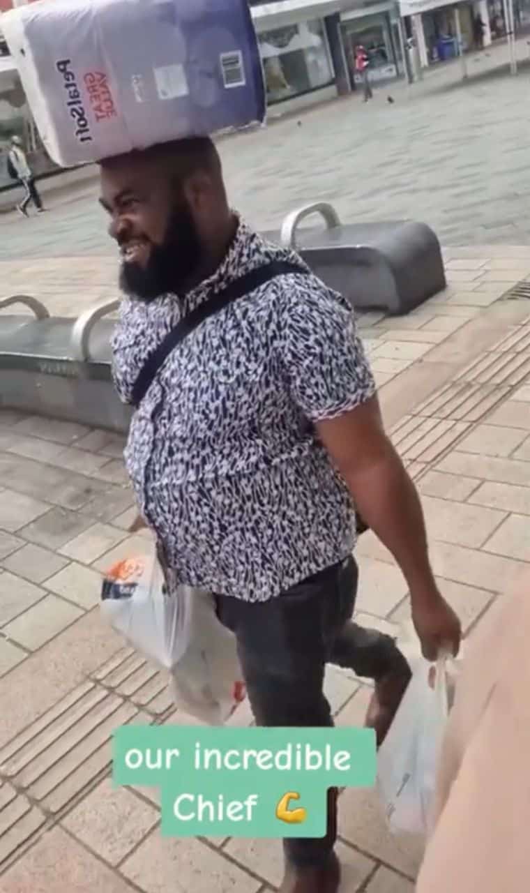 Wife gushes as Nigerian husband carries load on his head abroad (Video)