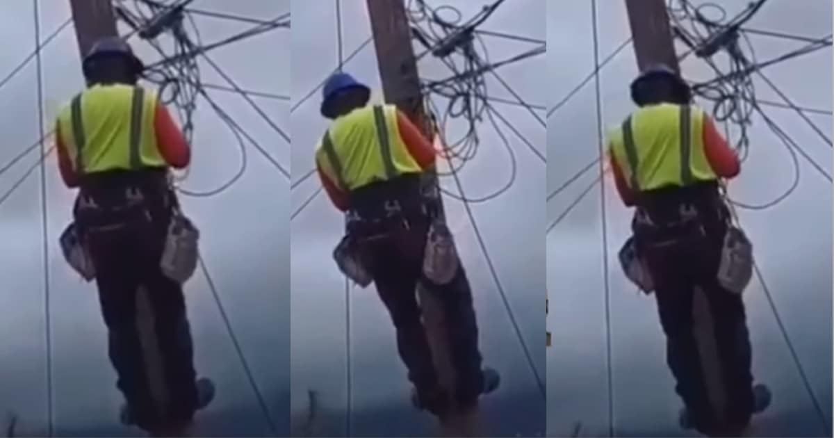 PHCN official dances on electric pole while disconnecting power