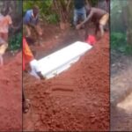 Heavy rain floods grave during funeral (Video)