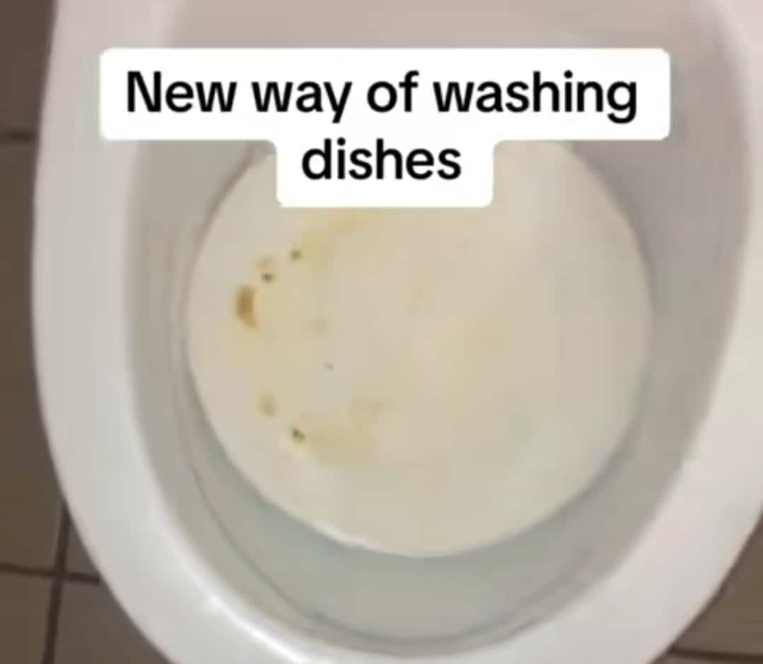 Nigerian man washing dishes dirty plate bathroom water closet