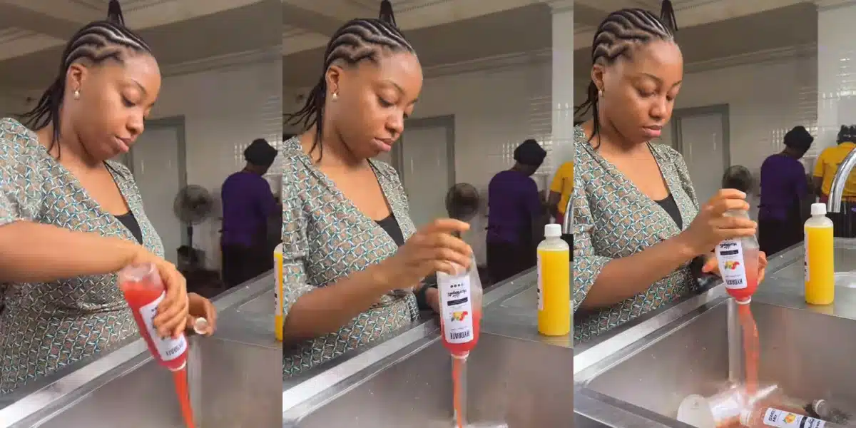 Nigerian business woman dispose several bottles of fruit juice after it got spoilt because of lack of electricity