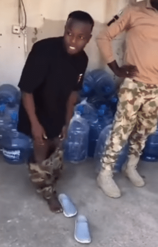 Video shows Nigerian soldiers dealing with a man caught wearing military camouflage