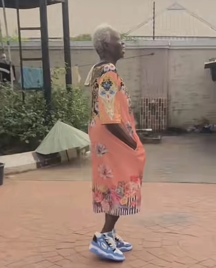 “Pablo mama don come back from UK” — Reactions as old woman stylishly steps out in gown and sneakers 