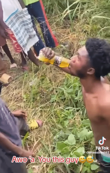 Moment thief is given energy drink to boost his strength for the jungle justice he was subjected to